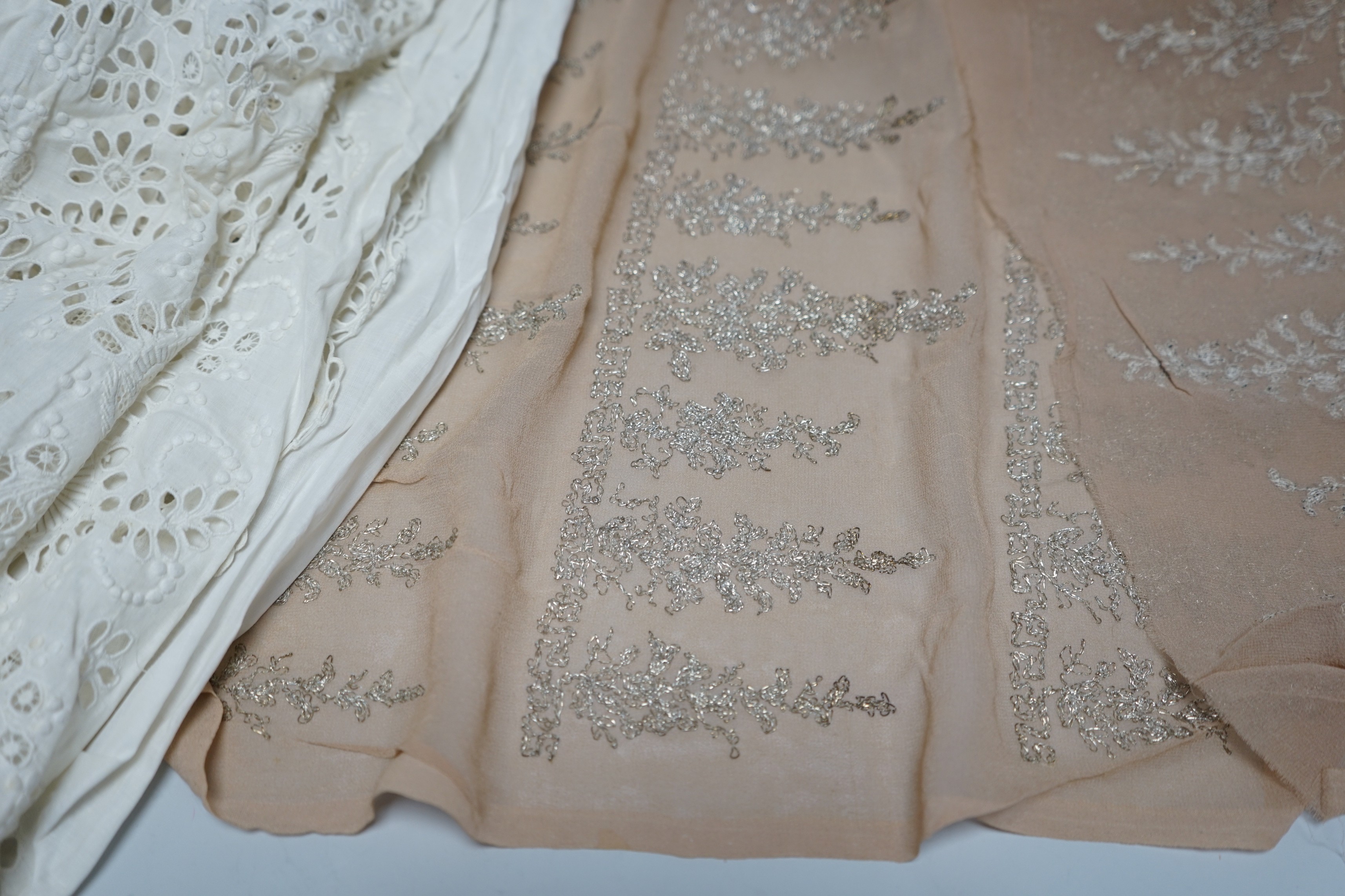 A long length of 1930’s silver lace trimming a similar panel, chiffon and silver embroidered fabric, an ornate 19th century cut worked christening gown etc